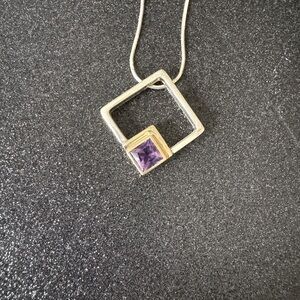 Elegant Silver and Gold Pendant with Purple Gemstone